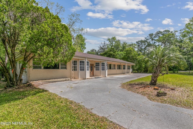 45121 Stratton Rd, Callahan, FL 32011 - single story home featuring driveway, a front yard, and brick siding
