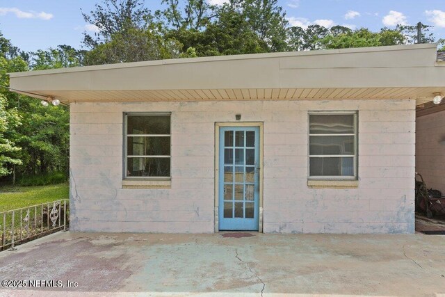 45121 Stratton Rd, Callahan, FL 32011 - back of property with fence, concrete block siding, and a patio area