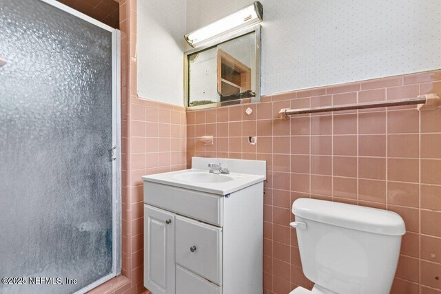 45121 Stratton Rd, Callahan, FL 32011 - bathroom with tile walls, wainscoting, a shower stall, and vanity