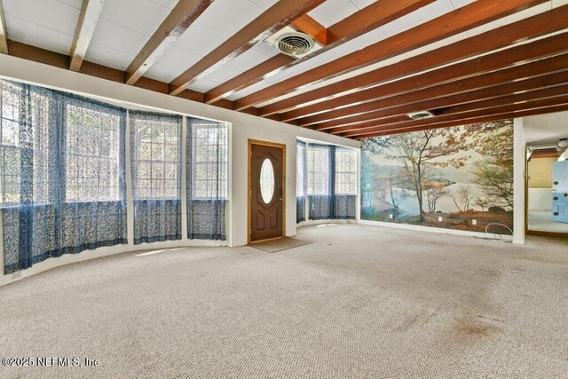 45121 Stratton Rd, Callahan, FL 32011 - unfurnished living room with carpet flooring, beamed ceiling, and visible vents
