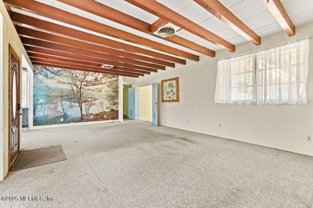 45121 Stratton Rd, Callahan, FL 32011 - unfurnished living room featuring visible vents, beam ceiling, carpet, and a healthy amount of sunlight