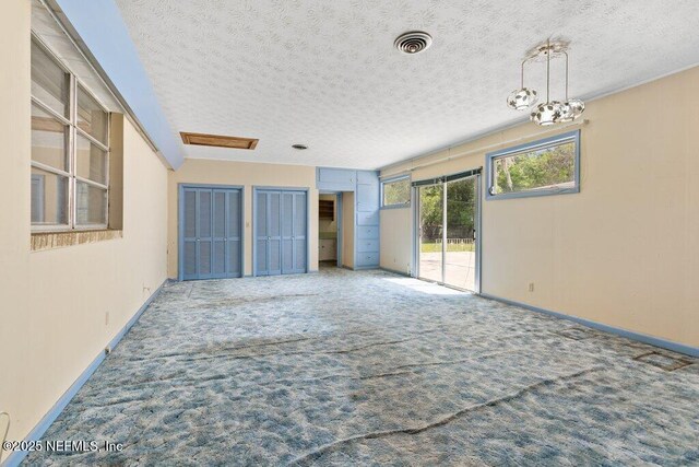 45121 Stratton Rd, Callahan, FL 32011 - spare room featuring carpet, visible vents, a textured ceiling, and baseboards