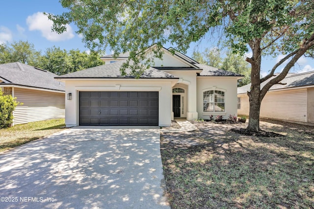 1829 Creekview Dr, Green Cove Springs, FL 32043 - view of front facade with an attached garage, concrete driveway, roof with shingles, and stucco siding