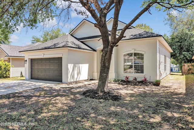 1829 Creekview Dr, Green Cove Springs, FL 32043 - view of front of home featuring an attached garage, stucco siding, roof with shingles, and concrete driveway