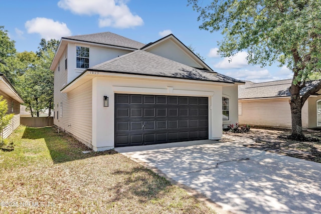 1829 Creekview Dr, Green Cove Springs, FL 32043 - view of front facade featuring an attached garage, fence, concrete driveway, and roof with shingles