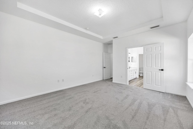 1829 Creekview Dr, Green Cove Springs, FL 32043 - unfurnished bedroom featuring a textured ceiling, baseboards, visible vents, carpet floors, and a raised ceiling