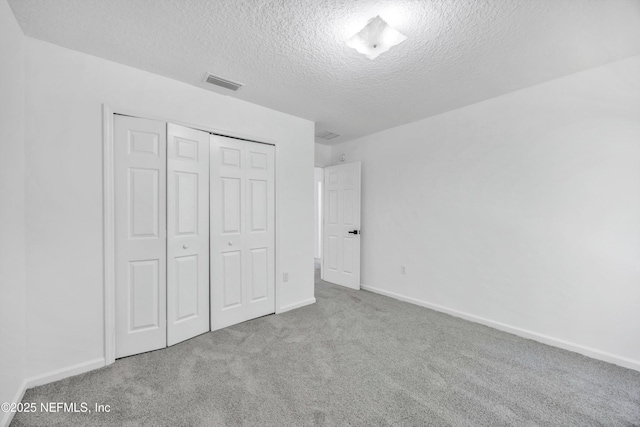 1829 Creekview Dr, Green Cove Springs, FL 32043 - unfurnished bedroom featuring visible vents, carpet floors, a closet, baseboards, and a textured ceiling