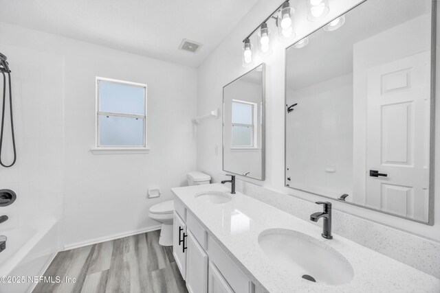 1829 Creekview Dr, Green Cove Springs, FL 32043 - full bathroom featuring toilet, wood finished floors, a sink, and visible vents