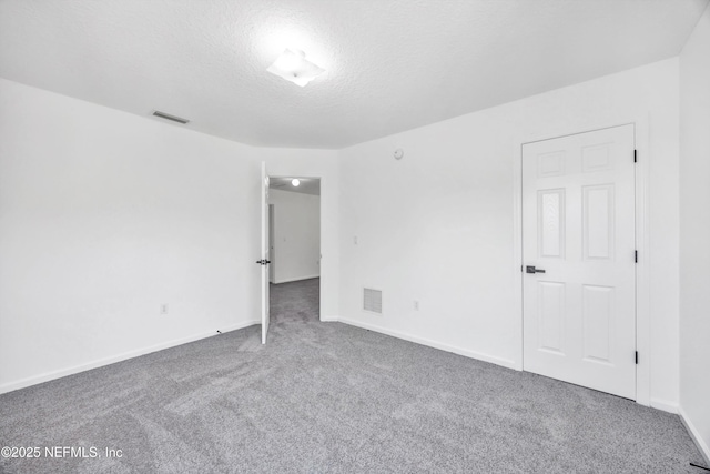 1829 Creekview Dr, Green Cove Springs, FL 32043 - unfurnished room with a textured ceiling, carpet floors, visible vents, and baseboards