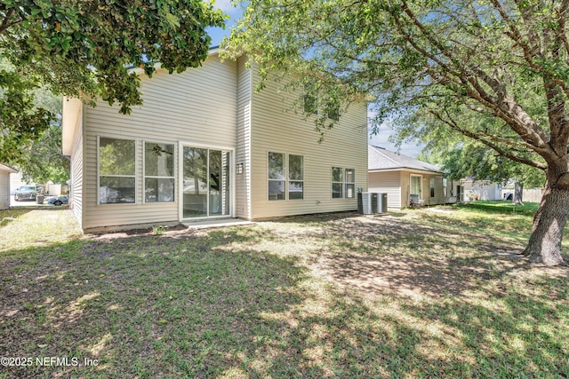 1829 Creekview Dr, Green Cove Springs, FL 32043 - rear view of property featuring central air condition unit and a lawn