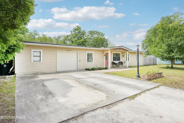 12054 Correa Ct, Jacksonville, FL 32246 - ranch-style house featuring a garage, driveway, a front lawn, and fence