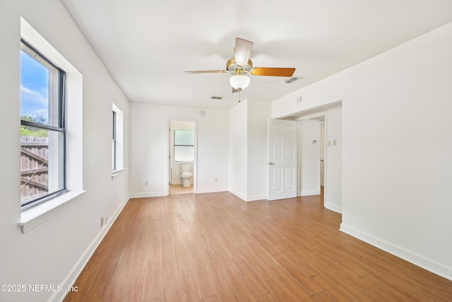 12054 Correa Ct, Jacksonville, FL 32246 - empty room featuring light wood finished floors, baseboards, a wealth of natural light, and ceiling fan