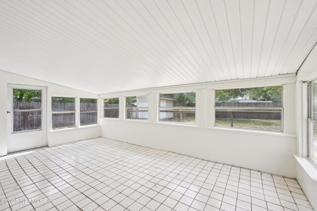 12054 Correa Ct, Jacksonville, FL 32246 - unfurnished sunroom featuring lofted ceiling, a wealth of natural light, and tile patterned floors