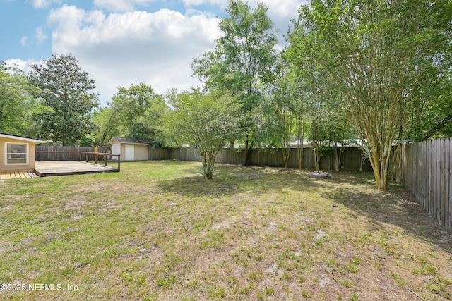 12054 Correa Ct, Jacksonville, FL 32246 - view of yard featuring a fenced backyard, an outdoor structure, a shed, and a deck