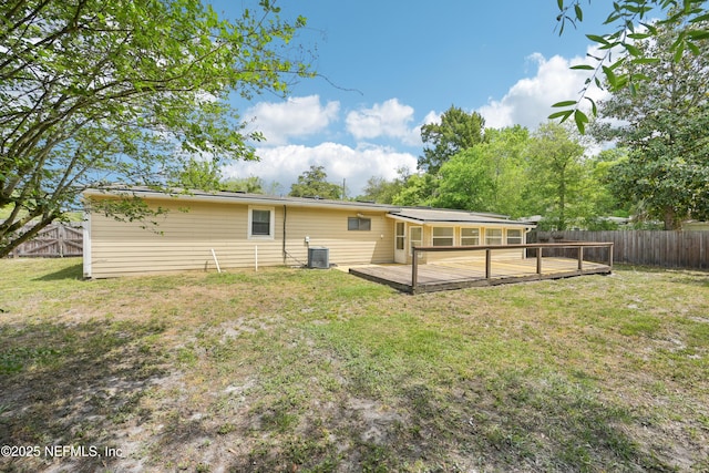 12054 Correa Ct, Jacksonville, FL 32246 - back of house featuring a fenced backyard, a wooden deck, a yard, and central AC