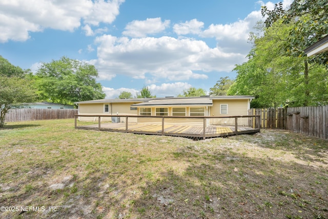 12054 Correa Ct, Jacksonville, FL 32246 - rear view of house featuring a fenced backyard, a wooden deck, and a lawn