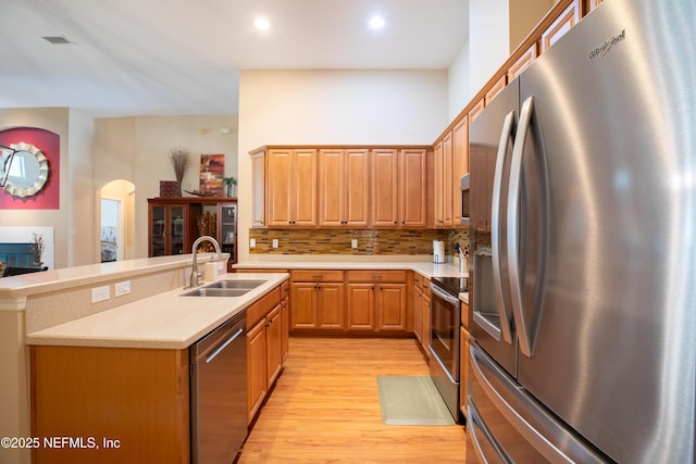 920 Gallier Pl, Jacksonville, FL 32259 - kitchen with stainless steel appliances, a sink, backsplash, light wood-style floors, and light countertops