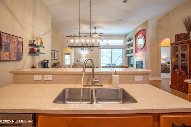 920 Gallier Pl, Jacksonville, FL 32259 - kitchen with wood finished floors, a sink, open floor plan, arched walkways, and light countertops