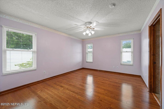 unfurnished room with ornamental molding, wood finished floors, a textured ceiling, and ceiling fan