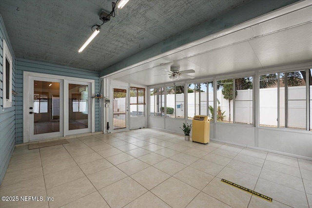 unfurnished sunroom with ceiling fan