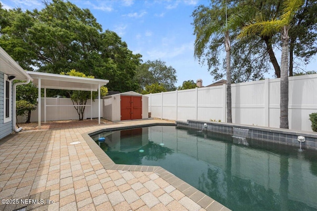 view of pool with a fenced backyard, a storage unit, an outdoor structure, and a fenced in pool