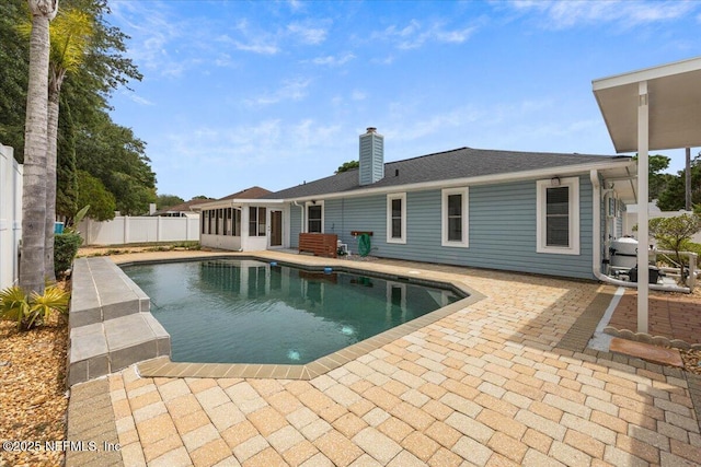 view of pool with a sunroom, fence, a patio area, and a fenced in pool