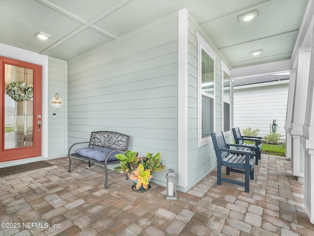 view of exterior entry with covered porch