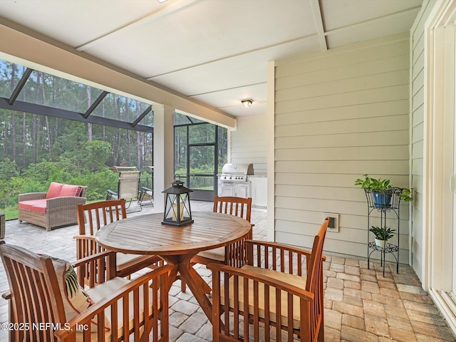 sunroom / solarium featuring outdoor dining area and plenty of natural light