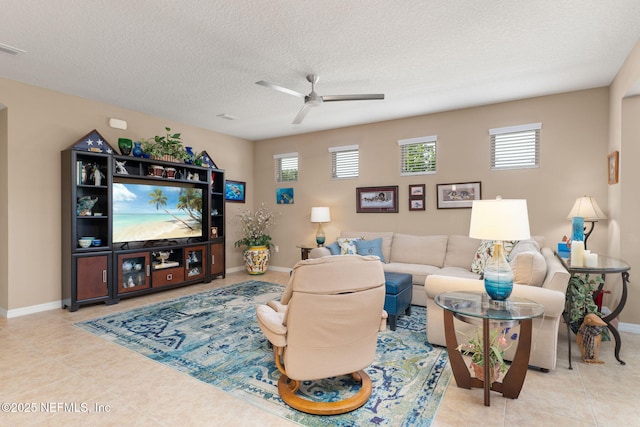tiled living room with a wealth of natural light, baseboards, and ceiling fan