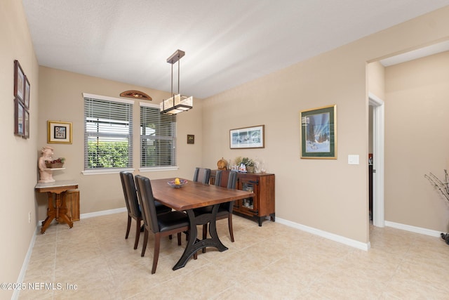 dining room featuring light tile patterned flooring and baseboards