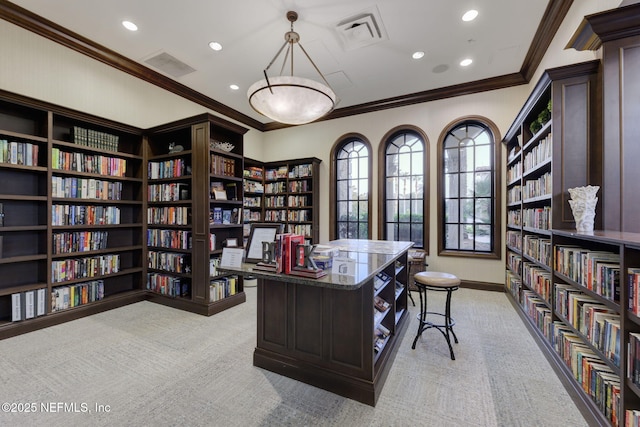 office with wall of books, visible vents, crown molding, and light carpet
