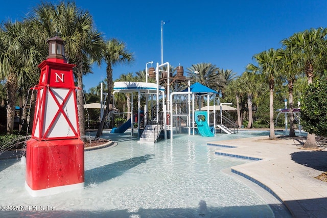 communal playground with a water play area and a community pool