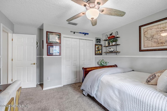 1104 Creekwood Way, Saint Johns, FL 32259 - bedroom with a closet, light carpet, a textured ceiling, and a ceiling fan