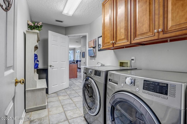 1104 Creekwood Way, Saint Johns, FL 32259 - washroom featuring cabinet space, washer and clothes dryer, and a textured ceiling