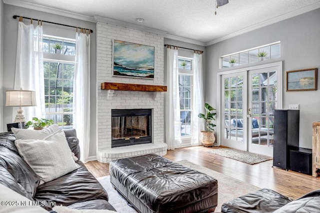 1104 Creekwood Way, Saint Johns, FL 32259 - living room with crown molding, wood finished floors, healthy amount of natural light, a brick fireplace, and a ceiling fan