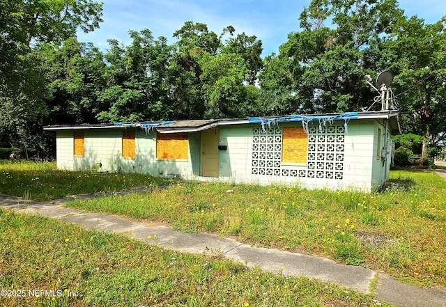 view of front of property with concrete block siding