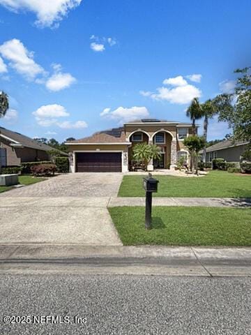 view of front facade with a garage, driveway, and a front yard