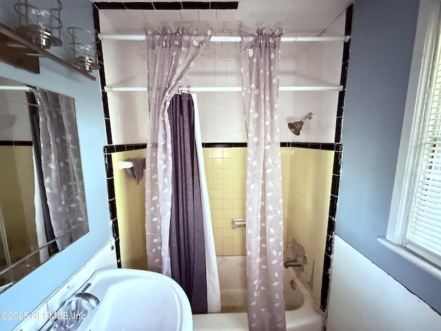 bathroom featuring a sink and shower / bath combo