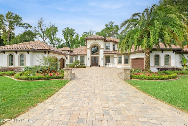 106 Villa Sovana Ct, Saint Johns, FL 32259 - mediterranean / spanish home with stucco siding, french doors, an attached garage, and decorative driveway