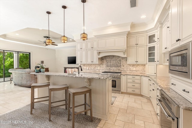 106 Villa Sovana Ct, Saint Johns, FL 32259 - kitchen with stainless steel appliances, ornamental molding, visible vents, open floor plan, and a tray ceiling