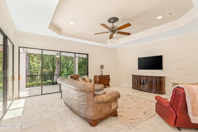 106 Villa Sovana Ct, Saint Johns, FL 32259 - living area featuring a tray ceiling, crown molding, visible vents, and ceiling fan