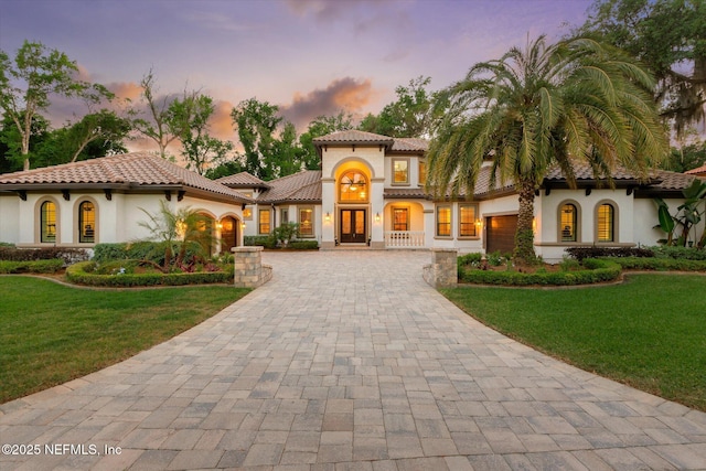106 Villa Sovana Ct, Saint Johns, FL 32259 - mediterranean / spanish home with stucco siding, french doors, a front lawn, and decorative driveway
