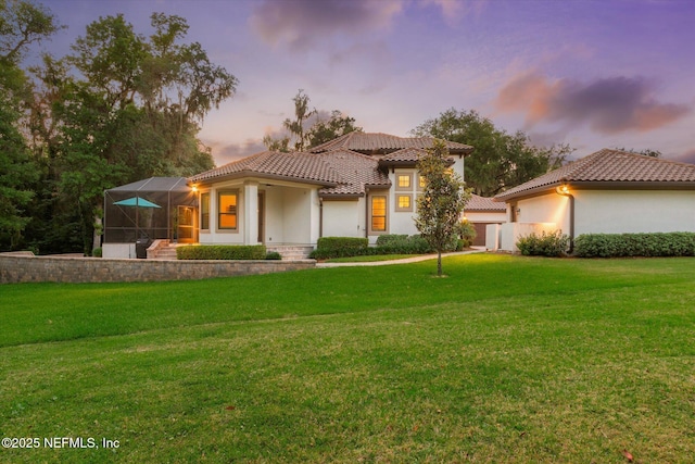 106 Villa Sovana Ct, Saint Johns, FL 32259 - view of front of home featuring glass enclosure, stucco siding, a front lawn, and a tiled roof