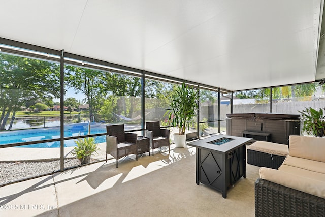 sunroom with plenty of natural light, expansive windows, carpet flooring, and a hot tub