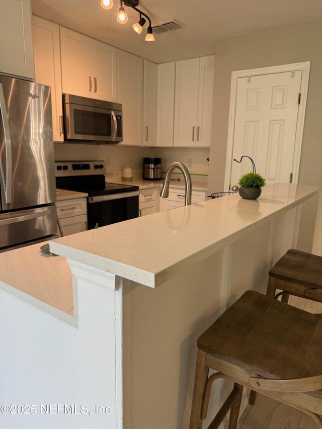 1500 Calming Water Dr Unit 5501, Fleming Island, FL 32003 - kitchen featuring a sink, appliances with stainless steel finishes, white cabinets, and light countertops