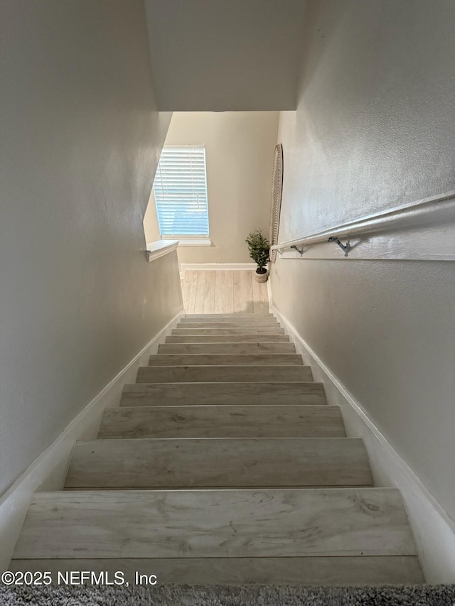 1500 Calming Water Dr Unit 5501, Fleming Island, FL 32003 - stairs with baseboards and wood finished floors