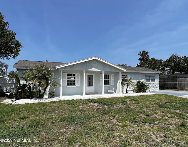 451 Whiting Ln, Atlantic Beach, FL 32233 - view of front of home with fence, a front yard, and covered porch