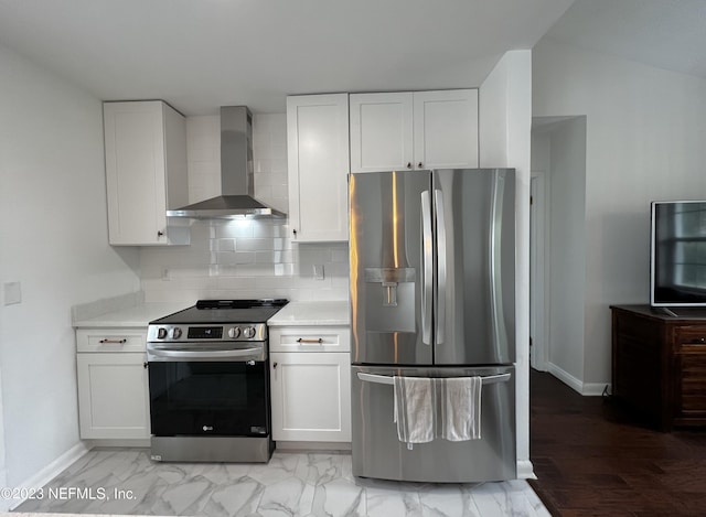 451 Whiting Ln, Atlantic Beach, FL 32233 - kitchen featuring wall chimney range hood, appliances with stainless steel finishes, white cabinets, and light countertops