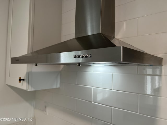 451 Whiting Ln, Atlantic Beach, FL 32233 - room details with wall chimney exhaust hood and white cabinetry