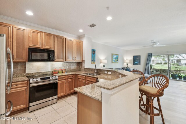 135 Bayberry Cir Unit 1608, Saint Augustine, FL 32086 - kitchen featuring light stone countertops, a sink, stainless steel appliances, visible vents, and a peninsula